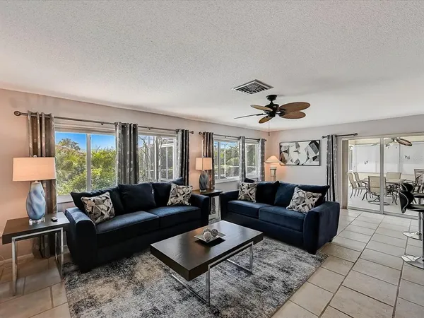 a front view of a house with a yard and trees