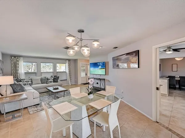 a view of a dining room with furniture wooden floor and chandelier