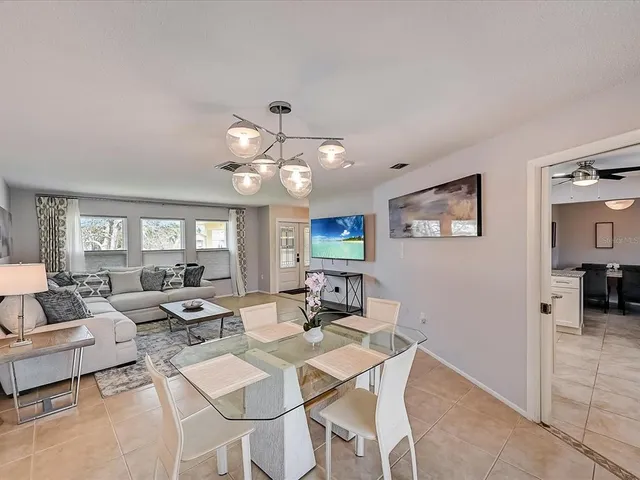 a view of a dining room with furniture wooden floor and chandelier