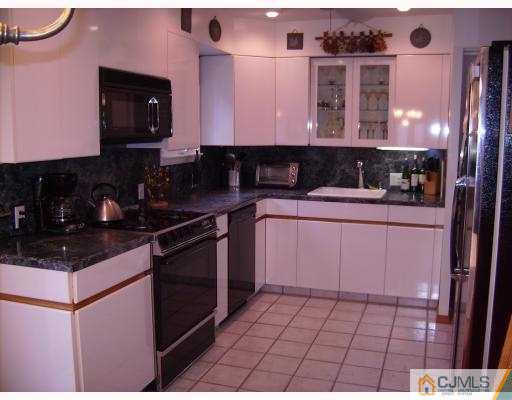 17 Finley Road Edison, NJ 08817 - Photo 3 of 10 a kitchen with stainless steel appliances granite countertop a sink stove and cabinets
