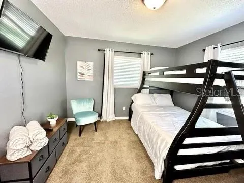 a bedroom with a bed and a chandelier