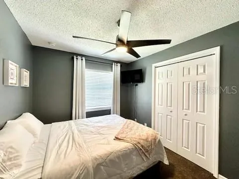 a bedroom with a bed and a desk