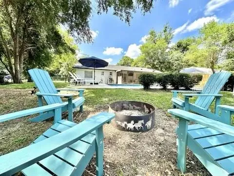 an aerial view of house with yard swimming pool and outdoor seating