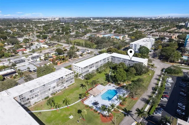 an aerial view of a residential building with parking space