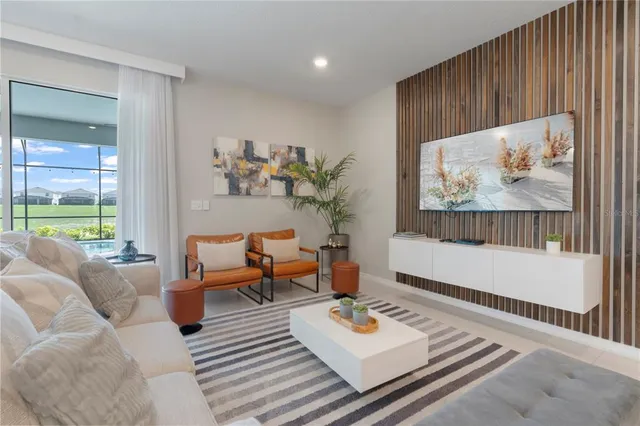 a living room with furniture and a painting on the wall