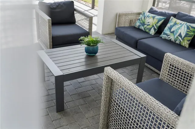 a large bed in a bedroom next to a window