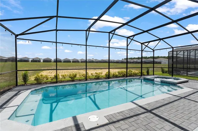 a bathroom with a granite countertop sink a mirror and a shower
