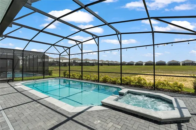 a bathroom with a granite countertop sink a large mirror and a toilet