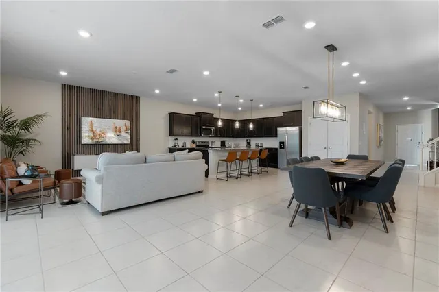 a living room with furniture and kitchen view