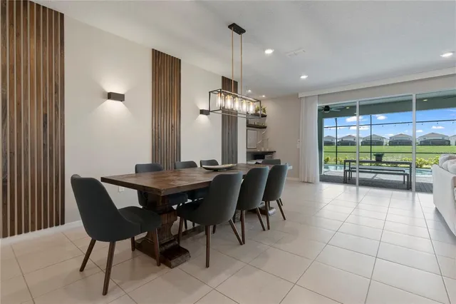a view of a dining room and livingroom with furniture window and wooden floor