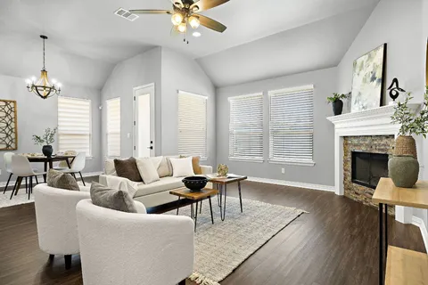 a living room with furniture and a fireplace