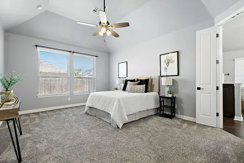 a spacious bedroom with a bed and a window