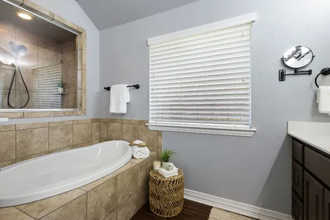 a bathroom with a bathtub and a window