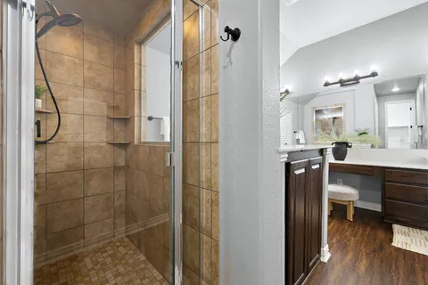 a bathroom with a sink a toilet and shower