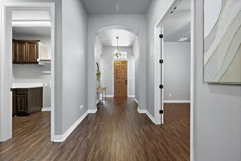 a view of a hallway with wooden floor and a fireplace