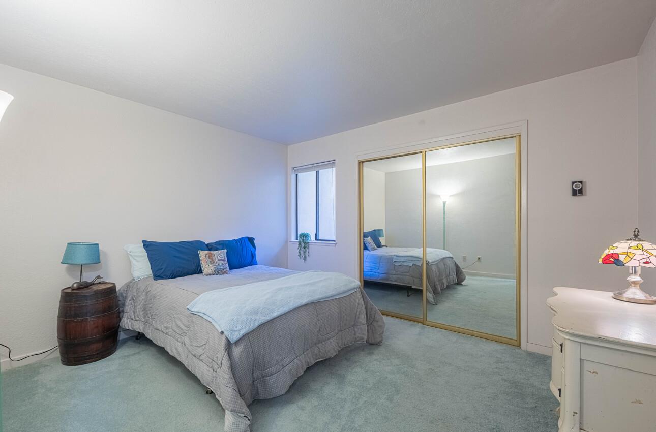 585 Hawthorne Street, Unit 103 Monterey, CA 93940 - Photo 26 of 30 a bedroom with a bed and a couch