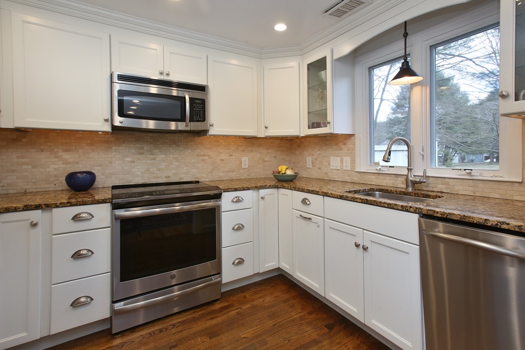 82 Jericho Road, Unit 82 Weston, MA 02493 - Photo 2 of 9 a kitchen with stainless steel appliances a stove microwave and sink