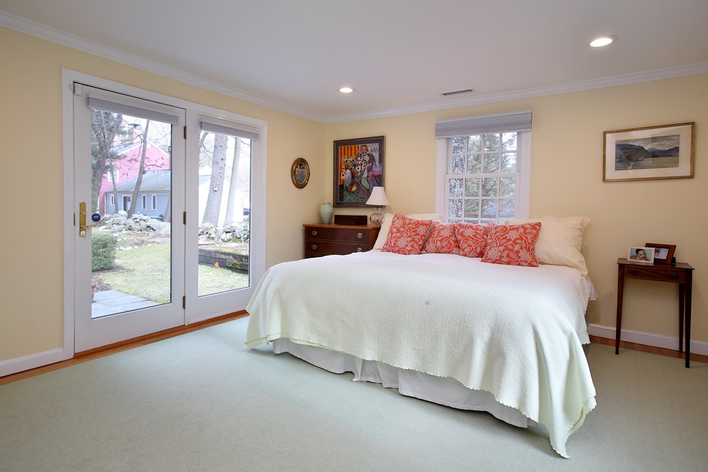 82 Jericho Road, Unit 82 Weston, MA 02493 - Photo 5 of 9 a spacious bedroom with a large bed and a large window