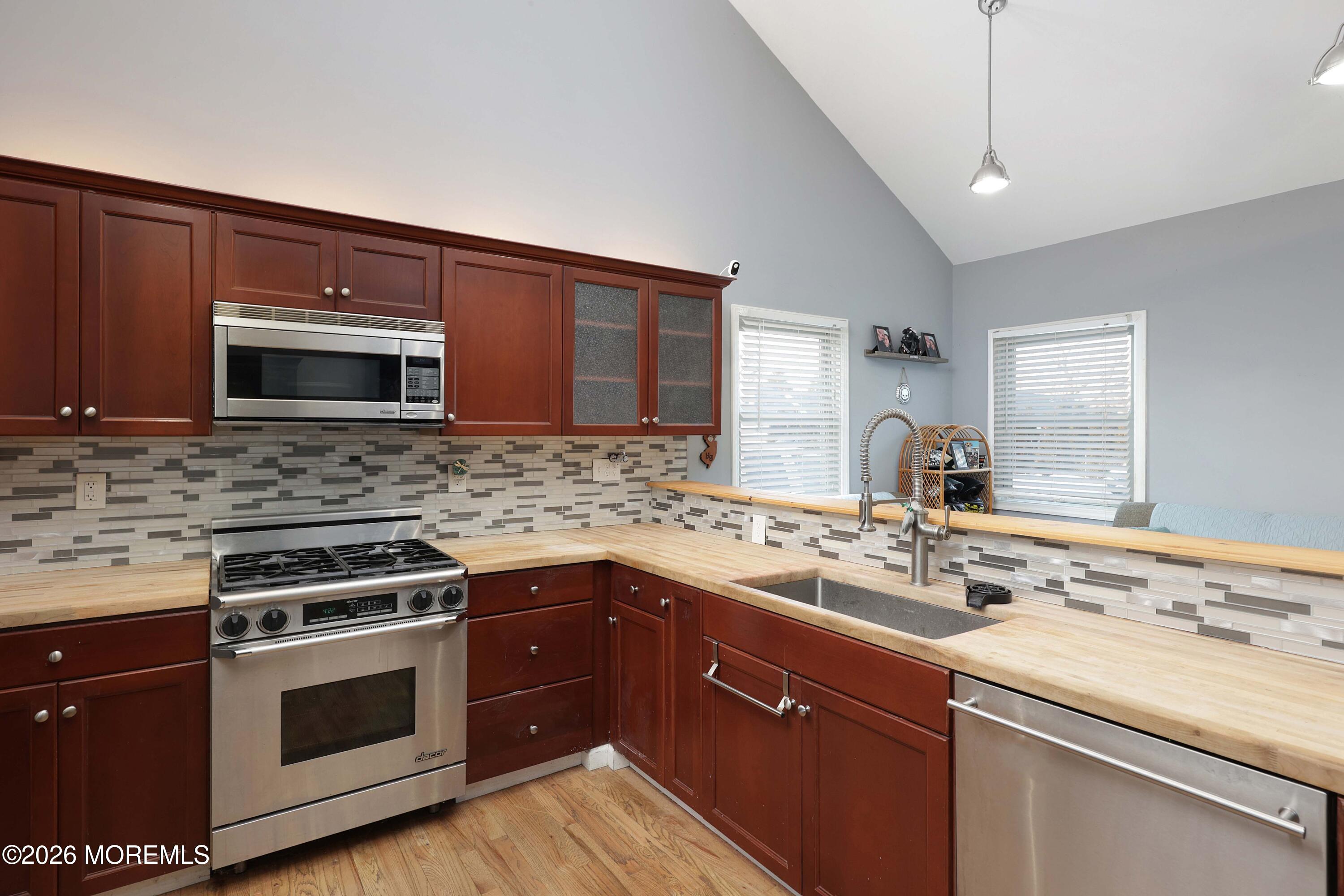 24 West Point Pleasant Avenue Ocean Gate, NJ 08740 - Photo 12 of 23 a kitchen with a sink stove and microwave