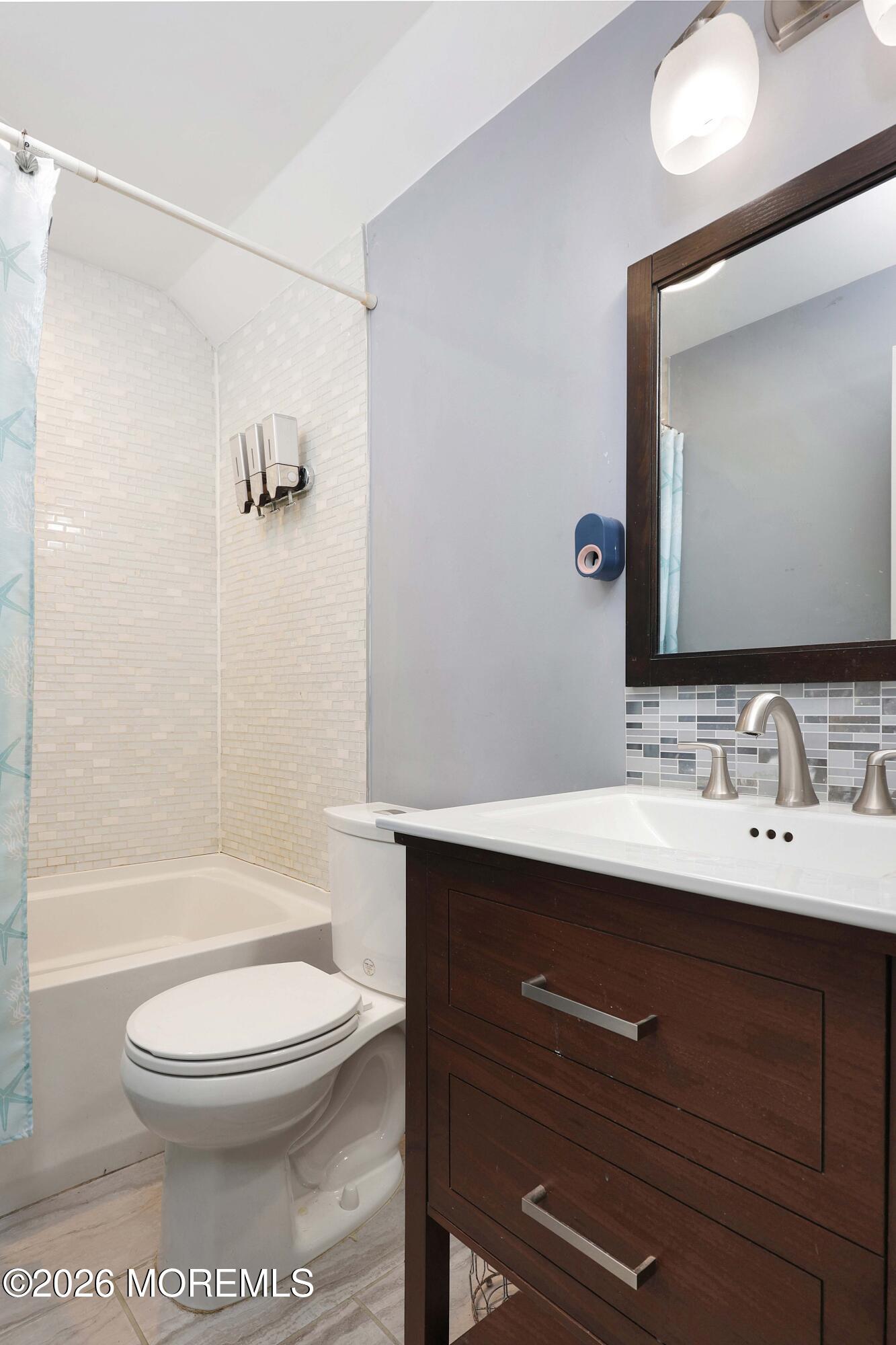 24 West Point Pleasant Avenue Ocean Gate, NJ 08740 - Photo 15 of 23 a bathroom with a toilet a sink a mirror and bathtub