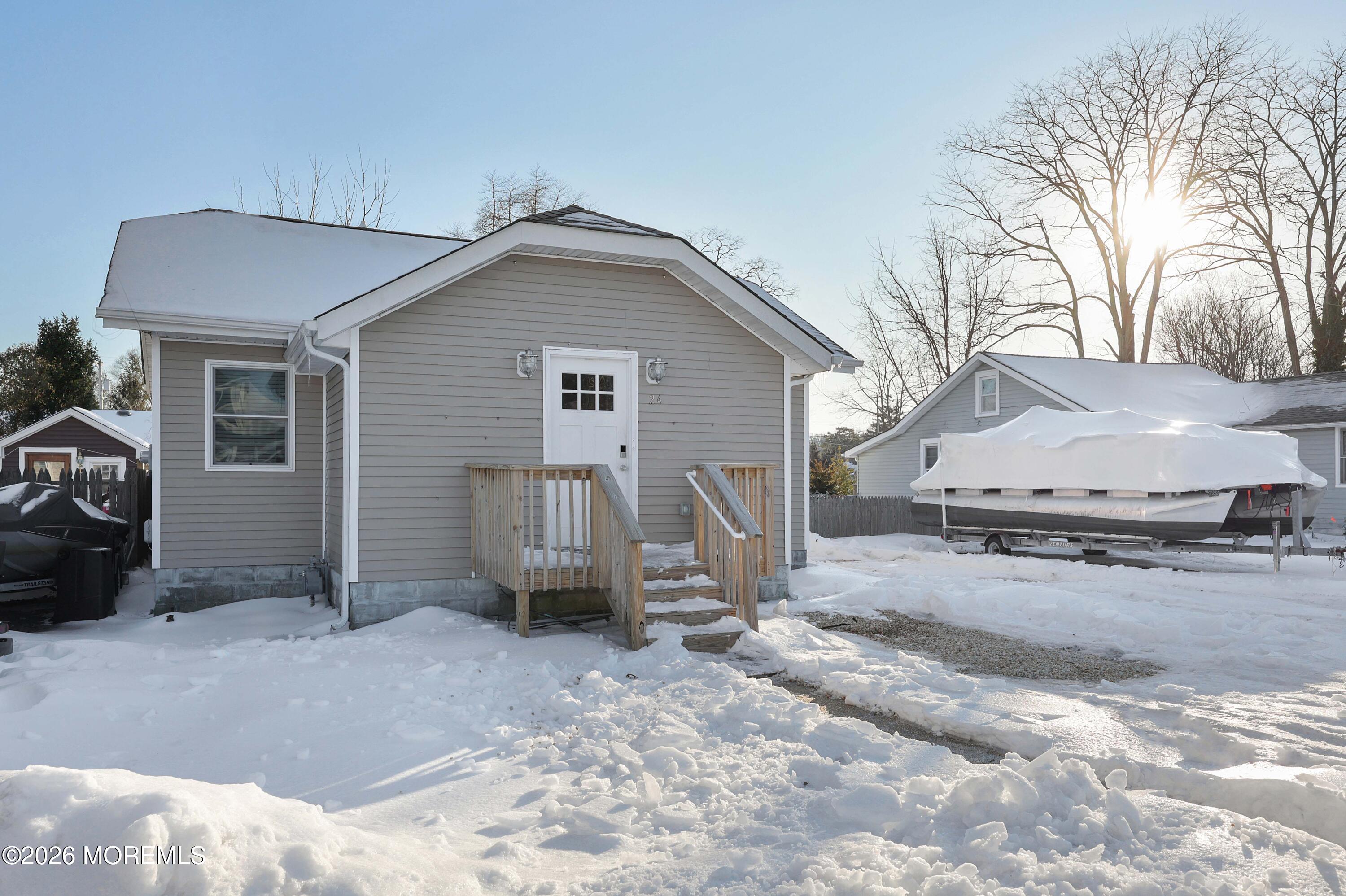 24 West Point Pleasant Avenue Ocean Gate, NJ 08740 - Photo 4 of 23 a view of a house with a snow in the yard