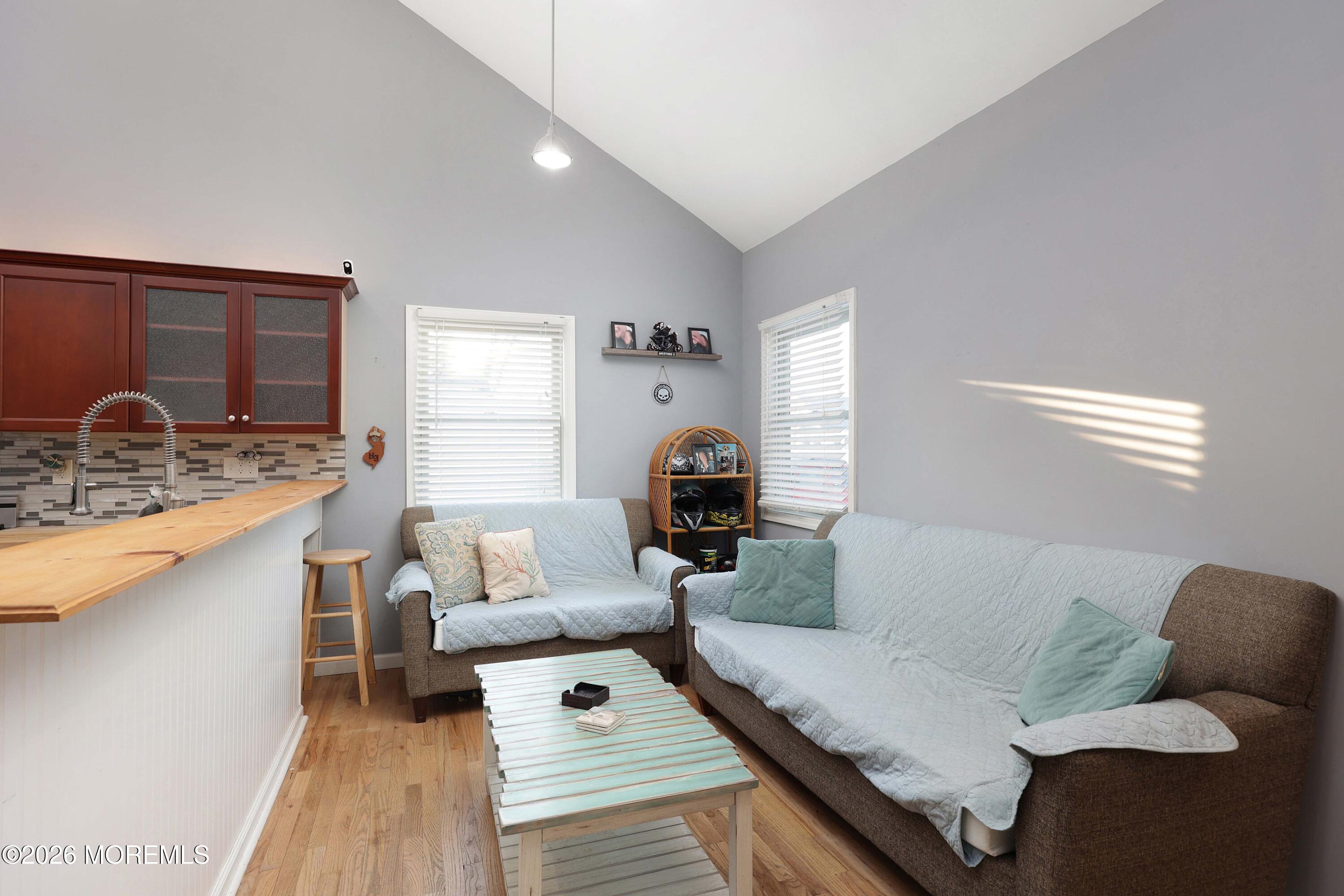 24 West Point Pleasant Avenue Ocean Gate, NJ 08740 - Photo 8 of 23 a living room with furniture and a wooden floor