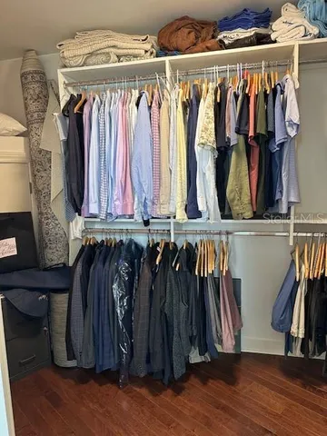 a view of walk in closet with clothes