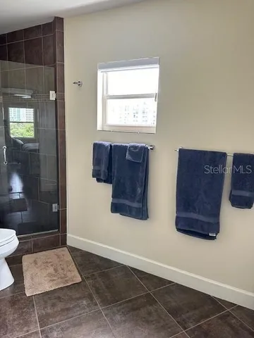 a view of an entryway with a window and wooden floor
