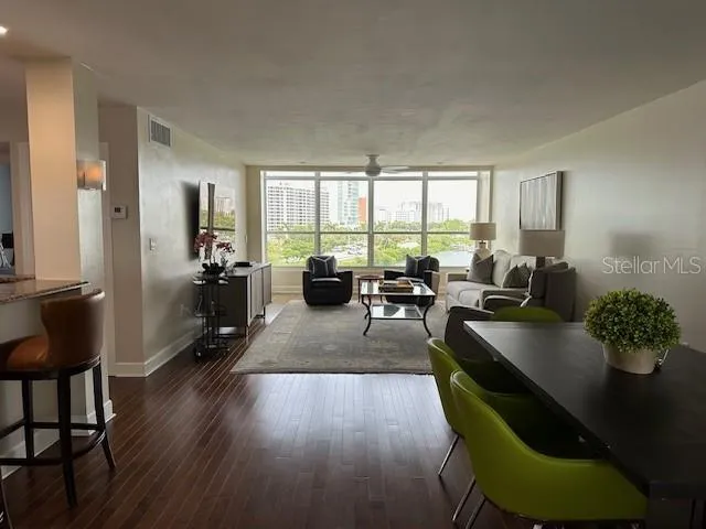a living room with furniture dining table and a large window
