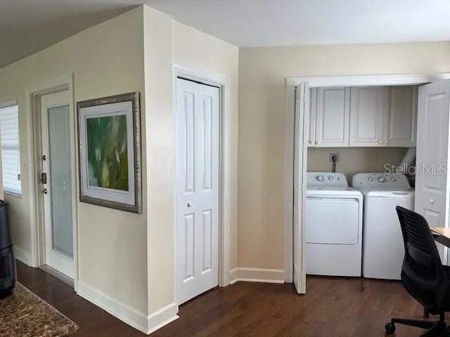 a view of a storage & utility room with closet wooden floor