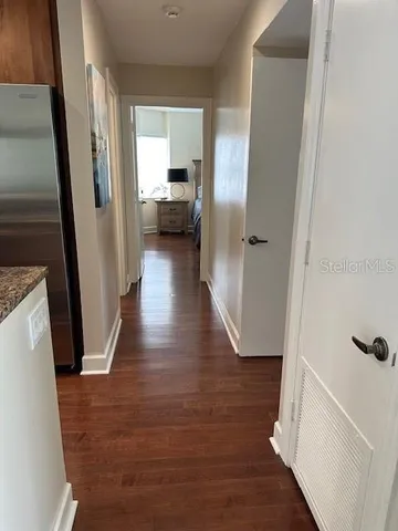 a view of a hallway view with wooden floor and staircase