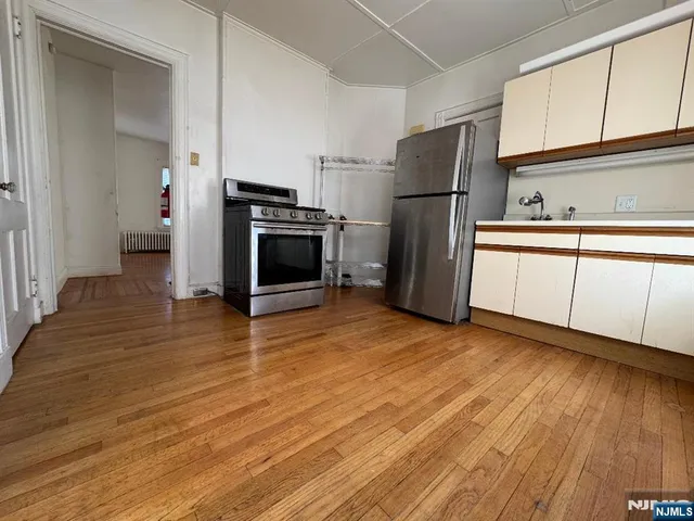 a kitchen with stainless steel appliances a refrigerator sink and microwave