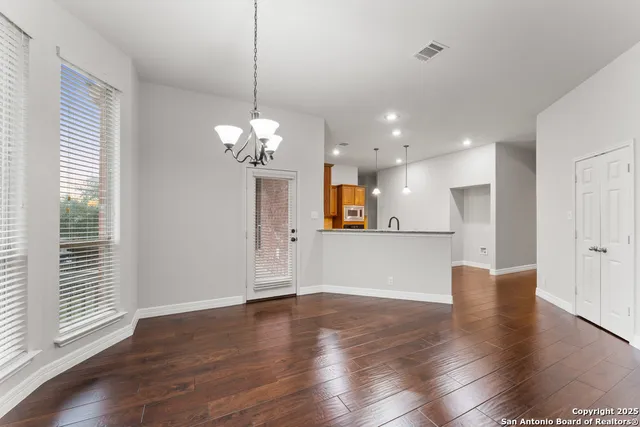 a view of a room with wooden floor and windows