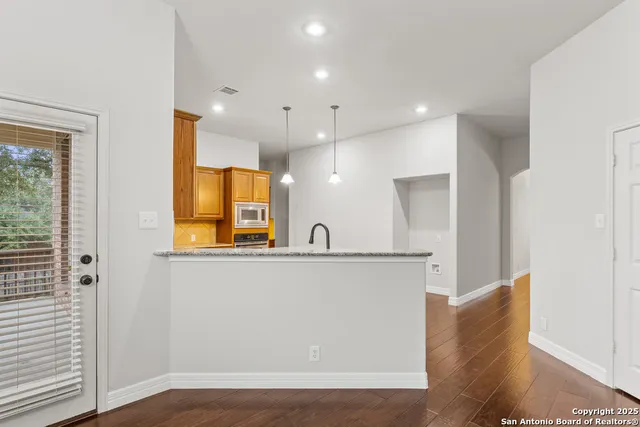 a view of cabinets with wooden floor and windows