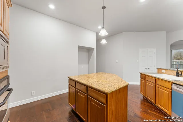 a kitchen with a stove a sink and a refrigerator