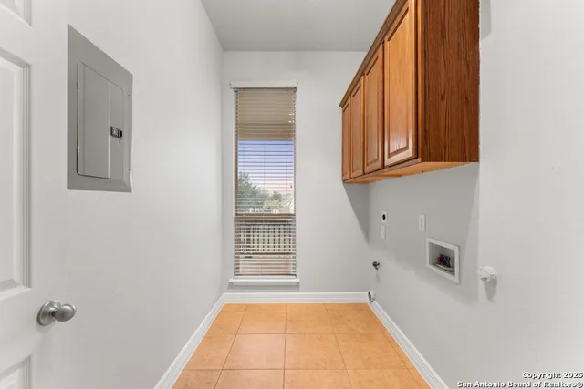 a view of a storage and utility room with wooden floor