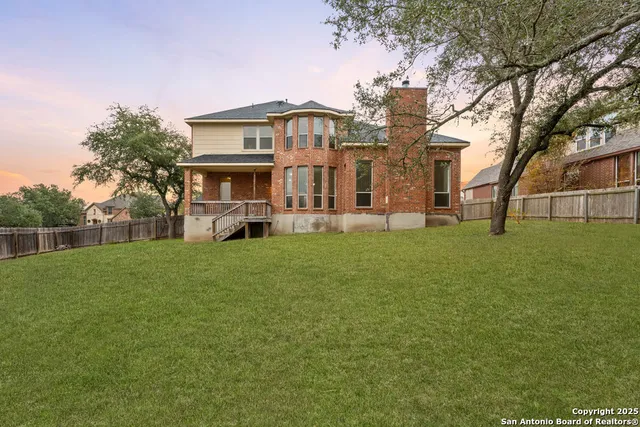 a view of backyard with large trees