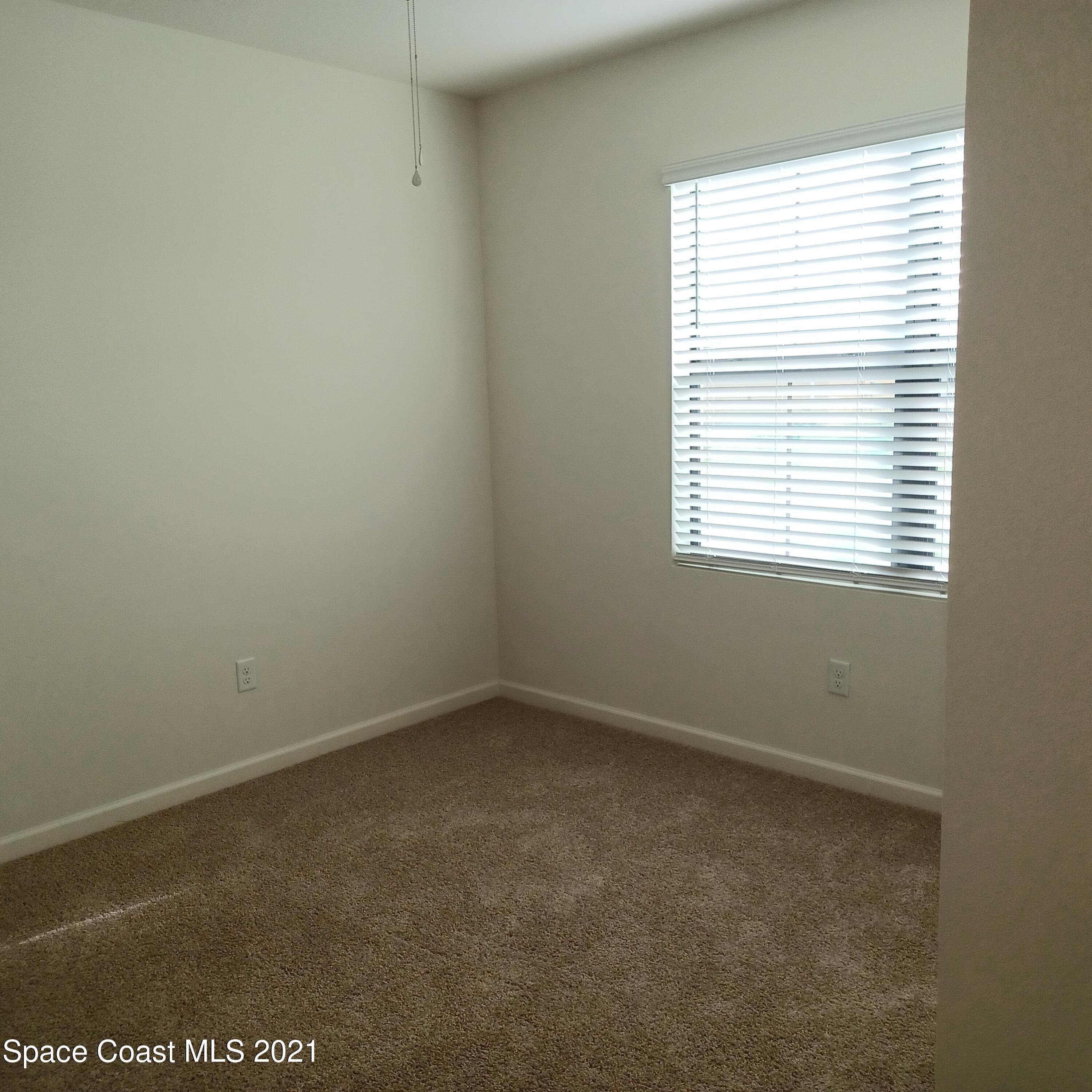 6558 Marble Road Cocoa, FL 32927 - Photo 7 of 16 an empty room with a window