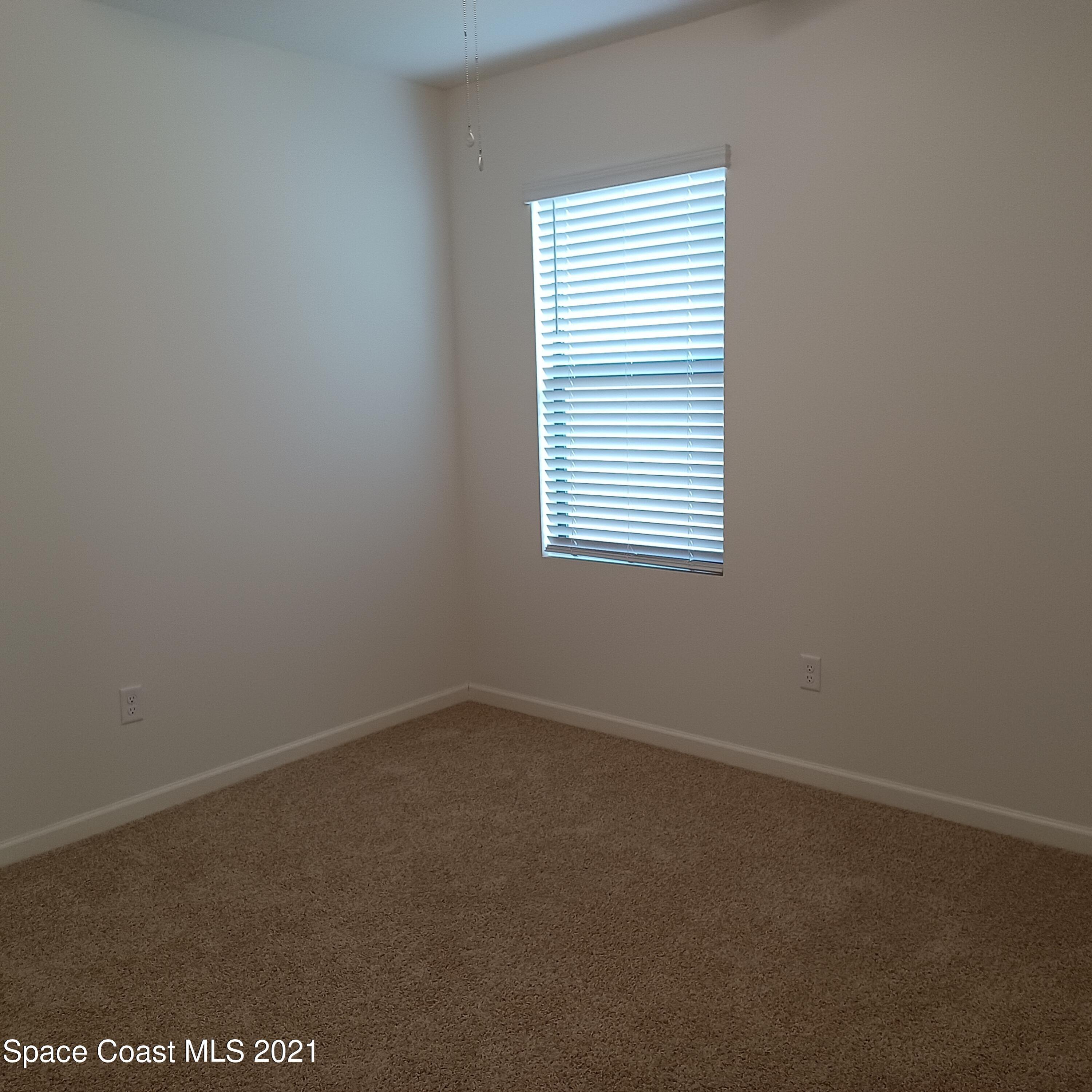6558 Marble Road Cocoa, FL 32927 - Photo 8 of 16 an empty room with a window