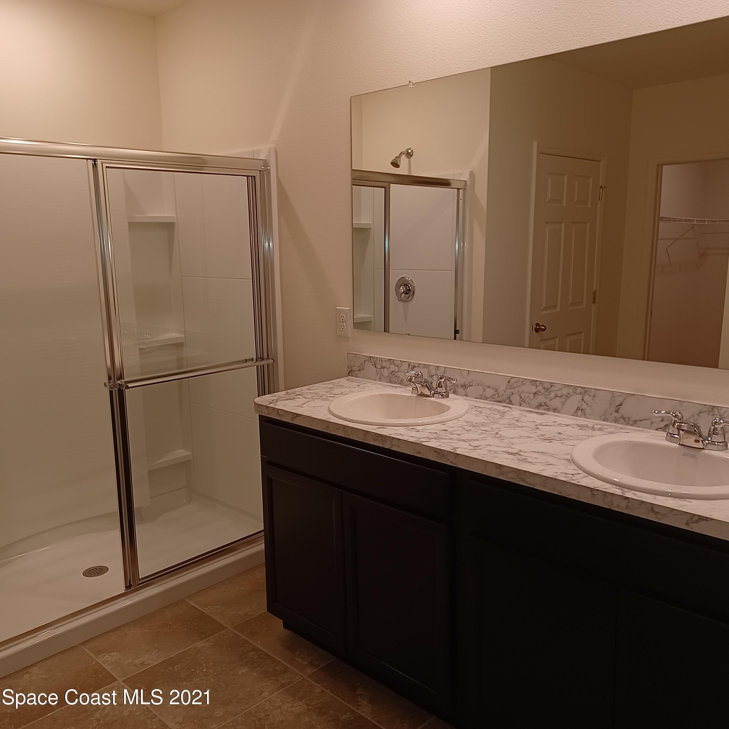 6558 Marble Road Cocoa, FL 32927 - Photo 10 of 16 a bathroom with a sink and a mirror