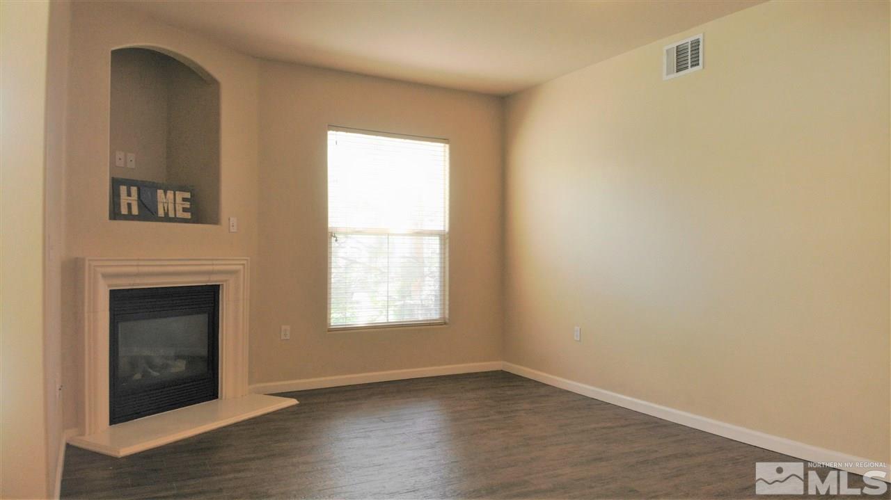 9050 Double R Boulevard, Unit 1612 Reno, NV 89521 - Photo 1 of 25 a view of an empty room with wooden floor and a window