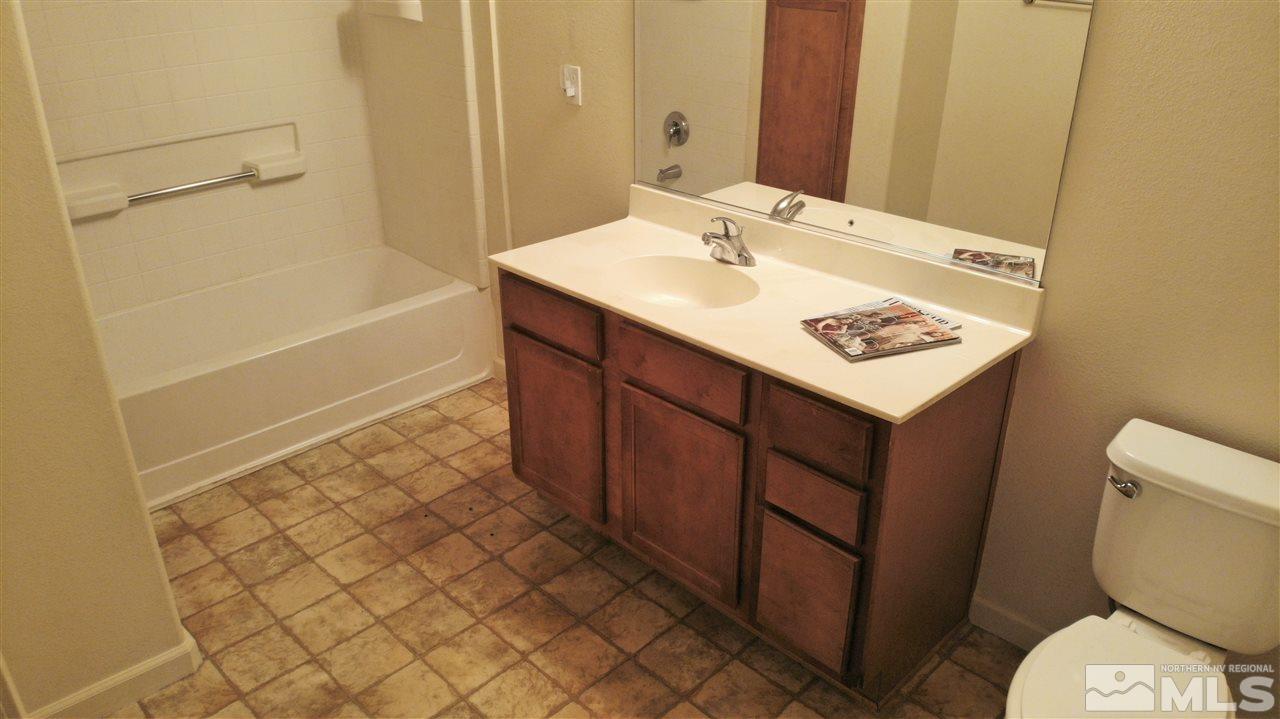 9050 Double R Boulevard, Unit 1612 Reno, NV 89521 - Photo 15 of 25 a bathroom with a sink a toilet and shower