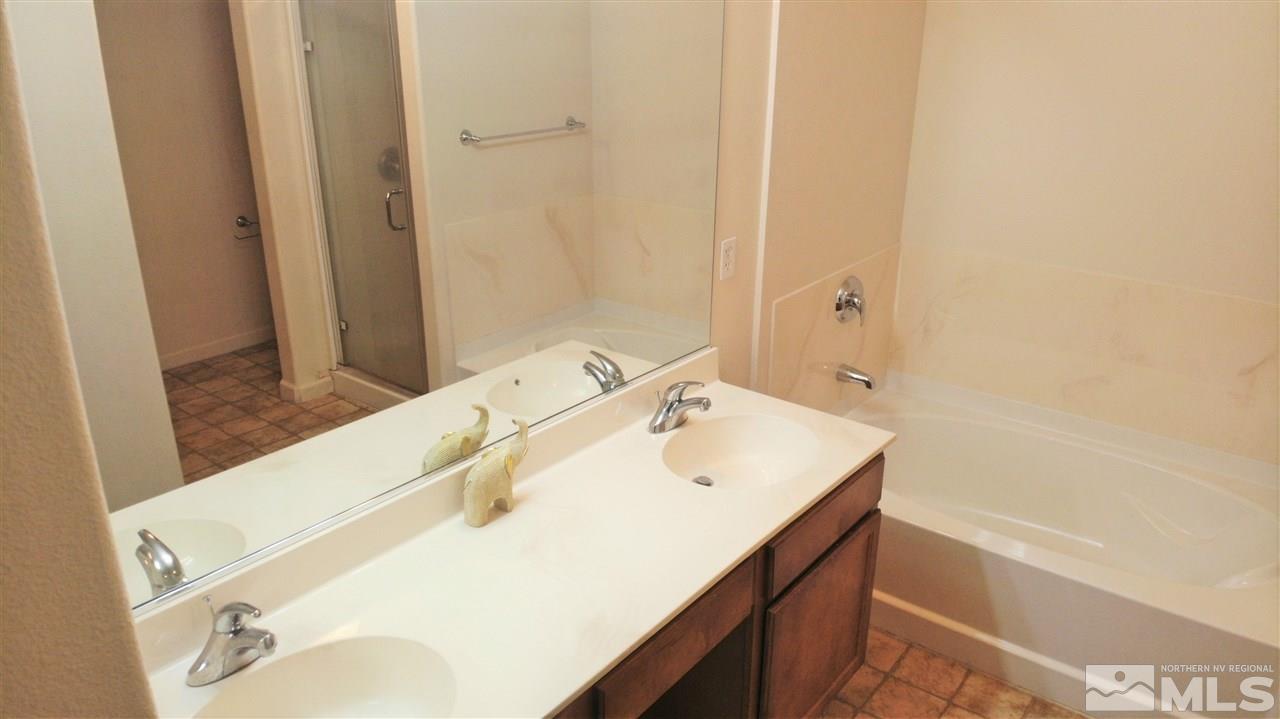9050 Double R Boulevard, Unit 1612 Reno, NV 89521 - Photo 17 of 25 a bathroom with a sink and a bathtub