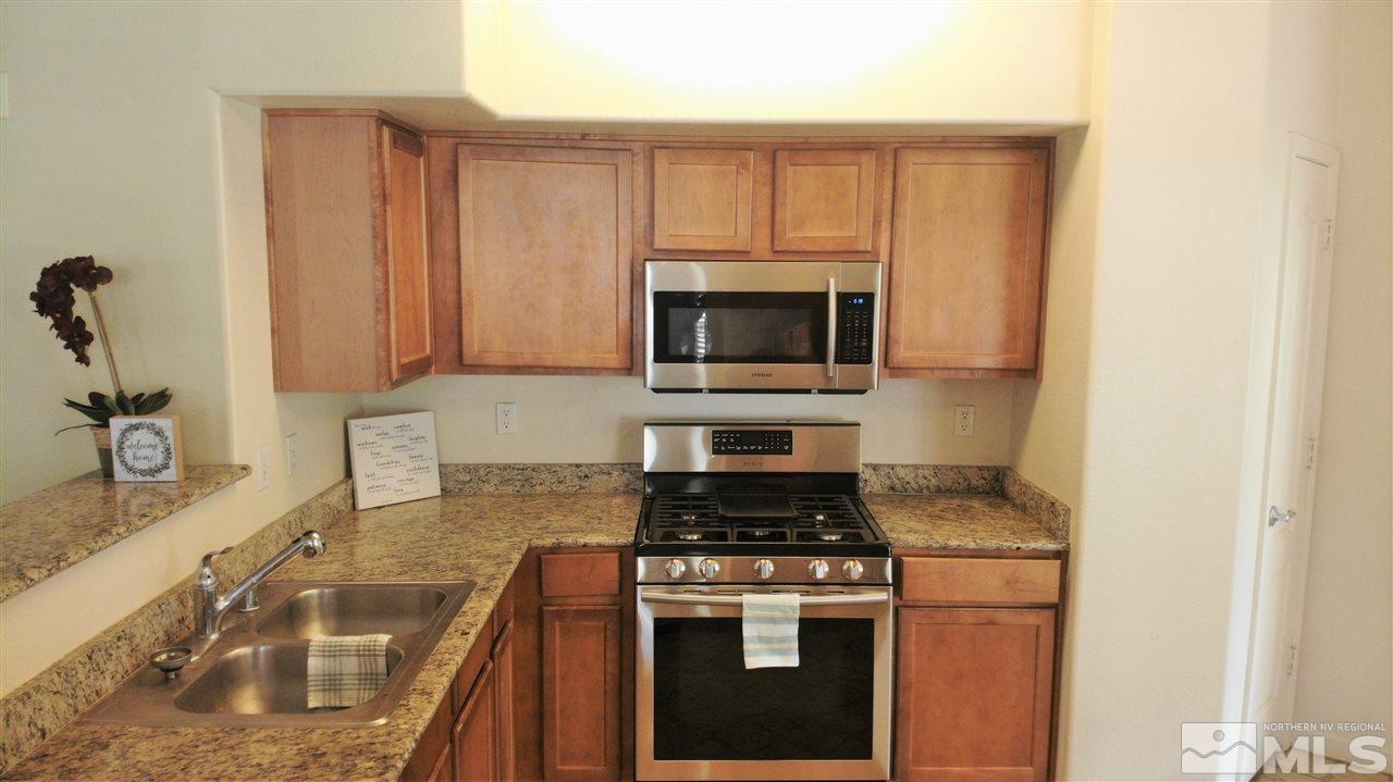 9050 Double R Boulevard, Unit 1612 Reno, NV 89521 - Photo 2 of 25 a kitchen with a stove and a sink