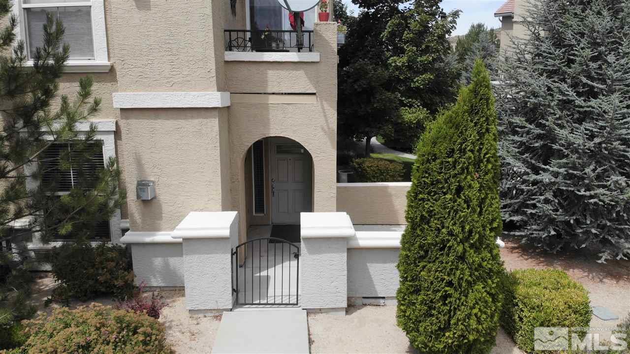 9050 Double R Boulevard, Unit 1612 Reno, NV 89521 - Photo 22 of 25 a view of a patio with table and chairs and potted plants