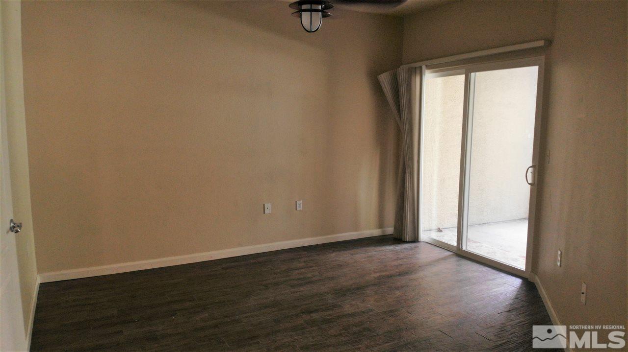 9050 Double R Boulevard, Unit 1612 Reno, NV 89521 - Photo 5 of 25 an empty room with wooden floor and windows