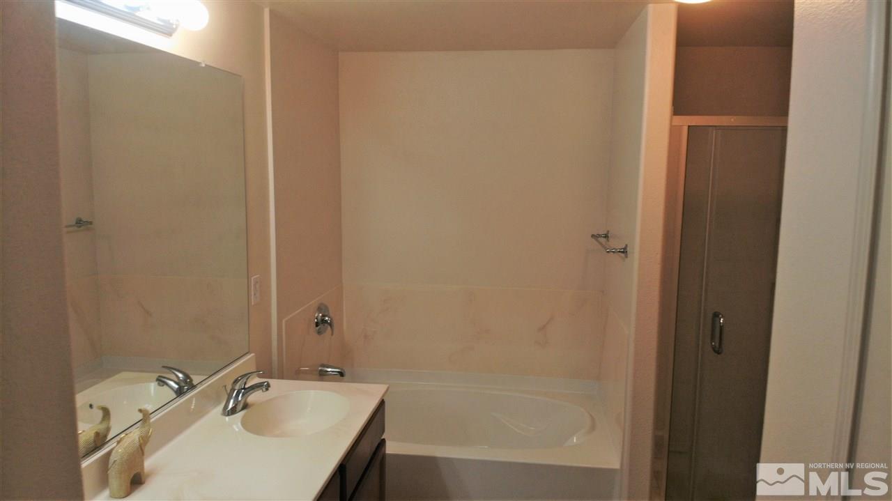 9050 Double R Boulevard, Unit 1612 Reno, NV 89521 - Photo 6 of 25 a bathroom with a sink and a bathtub