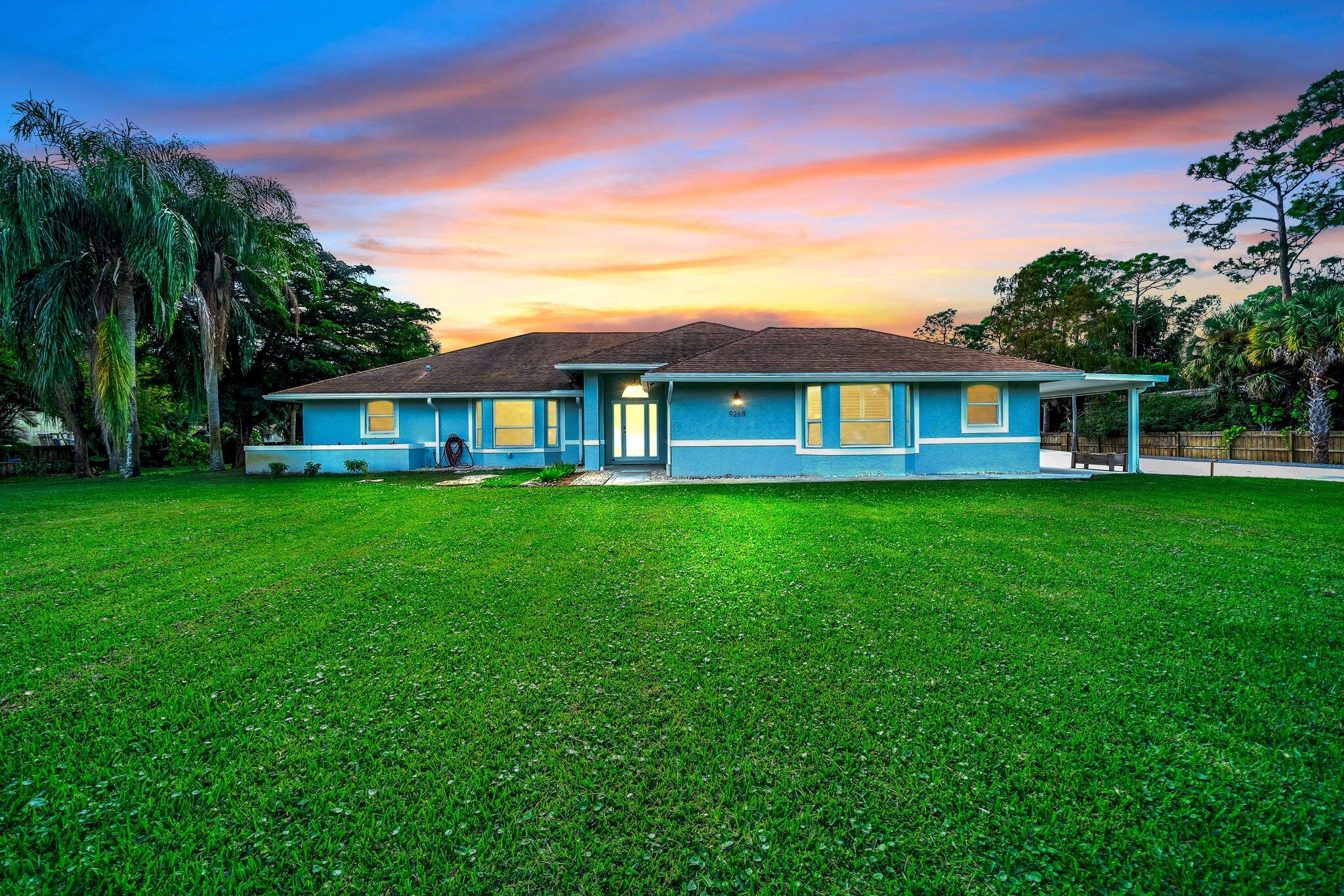 9268 Rodeo Drive Lake Worth, FL 33467 - Photo 1 of 66 a house view with a garden space