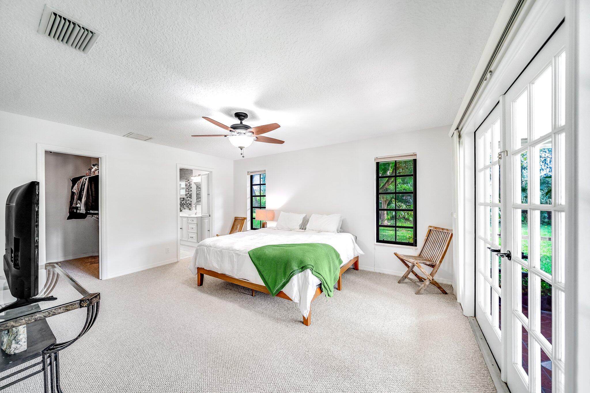 9268 Rodeo Drive Lake Worth, FL 33467 - Photo 17 of 66 a living room with a balcony furniture and a flat screen tv