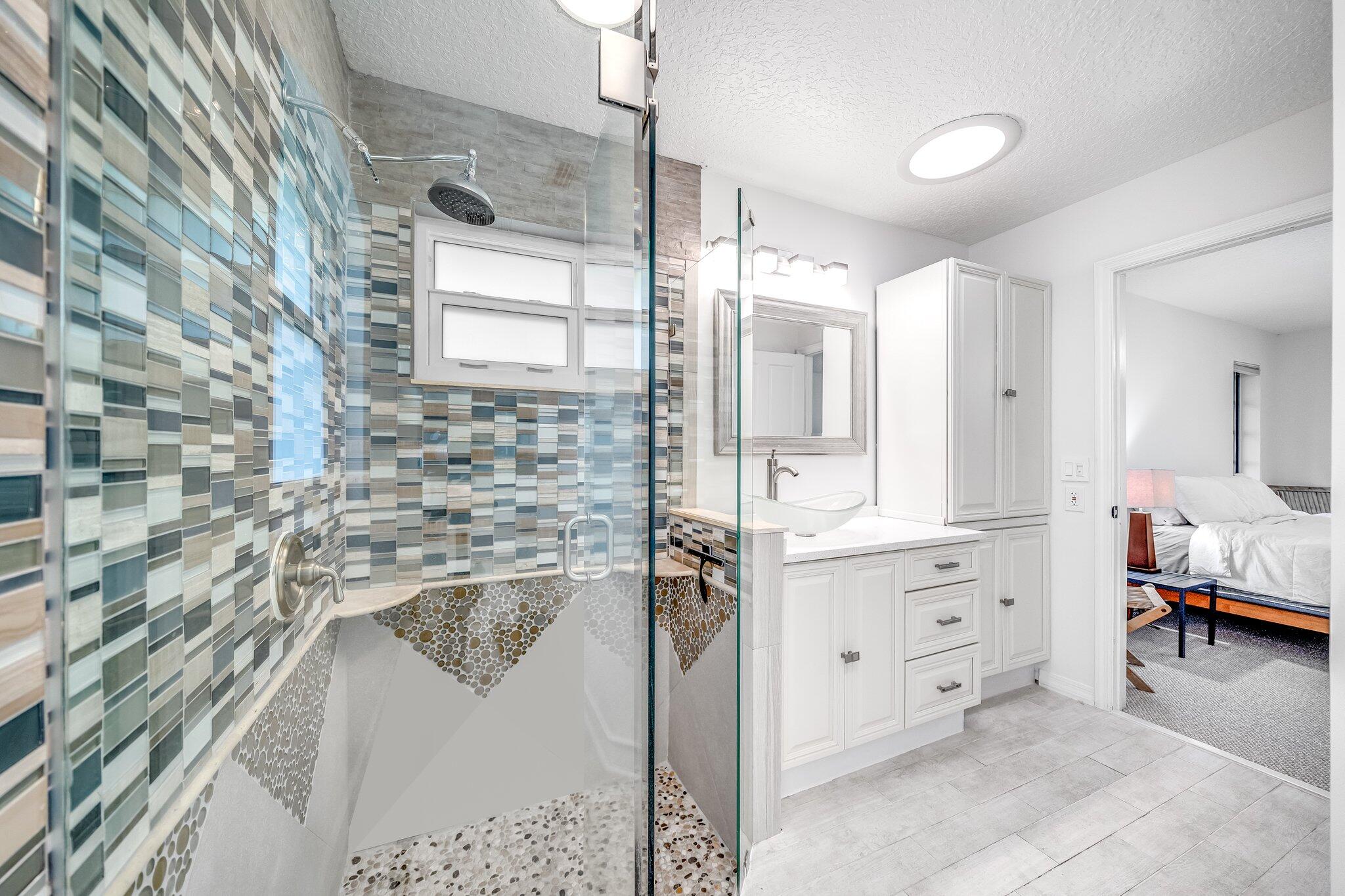 9268 Rodeo Drive Lake Worth, FL 33467 - Photo 20 of 66 a bathroom with a bathtub sink and mirror